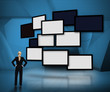 Group of blank screens on blue background with businesswoman loo