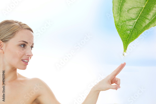 Photo: Blonde reaching out to dew drop falling from leaf Blonde reaching out to dew drop falling from leaf