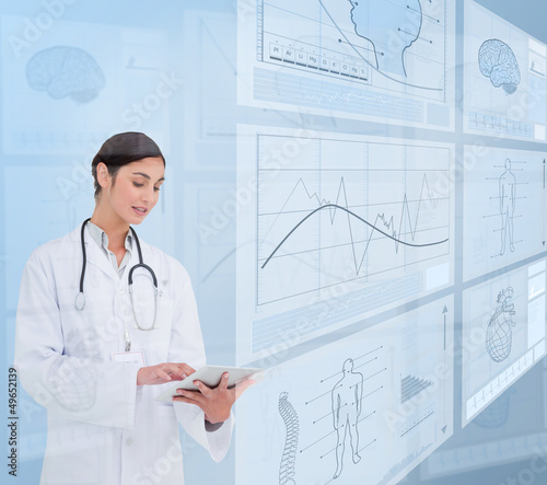 Photo: Woman doctor using a tablet pc Woman doctor using a tablet pc