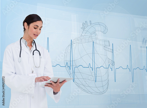 Photo: Cheerful cardiologist using a tablet pc Cheerful cardiologist using a tablet pc