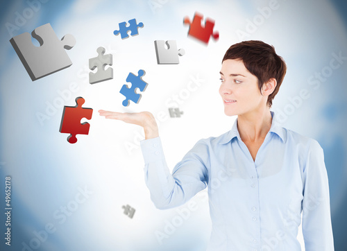 Photo: Cheerful woman with puzzles levitating Cheerful woman with puzzles levitating