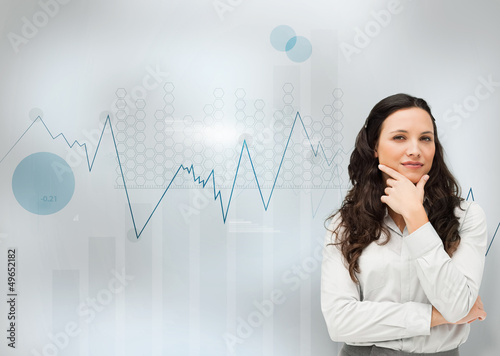Photo: Businesswoman standing with a digital graph Businesswoman standing with a digital graph