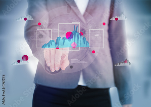 Photo: Businesswoman pointing to a graph on touchscreen Businesswoman pointing to a graph on touchscreen