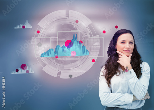 Photo: Businesswoman against a futuristic graph hologram Businesswoman against a futuristic graph hologram