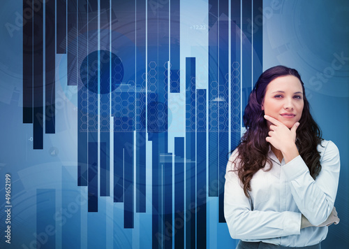 Photo: Businesswoman looking away against a digital background Businesswoman looking away against a digital background