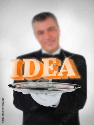 Photo: Smiling waiter offering ideas Smiling waiter offering ideas