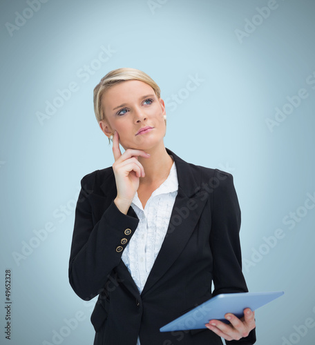 Photo: Thoughtful businesswoman with tablet pc Thoughtful businesswoman with tablet pc