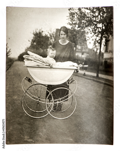 Photo: mother with baby in vintage buggy mother with baby in vintage buggy