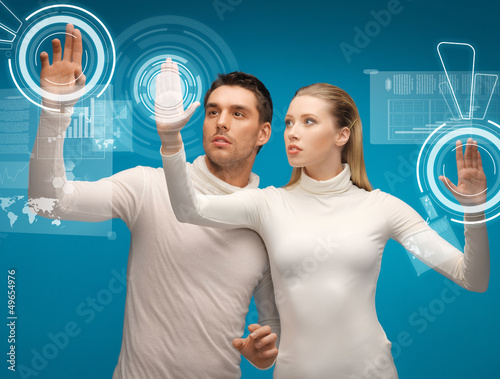 Photo: man and woman working with virtual screens man and woman working with virtual screens
