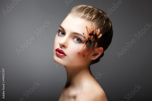 Photo: Woman with brachypelma smithi Spider creeping on her Face Woman with brachypelma smithi Spider creeping on her Face