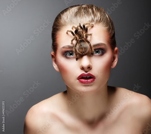 Photo: Scary Arachnid Predator on Beauty Woman Face sitting Scary Arachnid Predator on Beauty Woman Face sitting