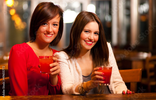 Photo: Friends having a round of drinks Friends having a round of drinks