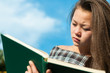 young asian girl reading outdoor