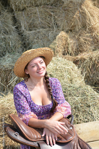 Photo: Girl resting near a haystack Girl resting near a haystack