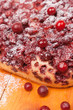 closeup sweet pie with fresh cowberry and cranberry on wooden
