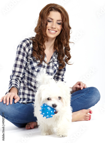 Photo: Caucasian young female lying on floor with her pet dog Caucasian young female lying on floor with her pet dog