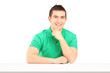 Young smiling man sitting