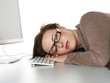 Business woman sleeping on her keyboard at work