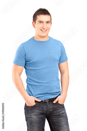 Photo: Smiling young man posing with hands in pockets Smiling young man posing with hands in pockets
