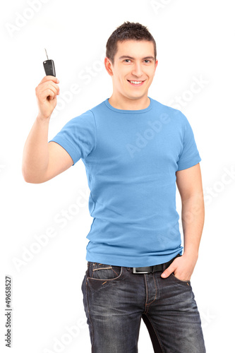 Photo: Young smiling guy holding car key Young smiling guy holding car key