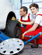 Car mechanics check the tread pattern of a winter tire