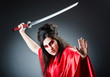Female sword warriod in dark studio