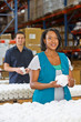 Factory Worker Checking Goods On Production Line