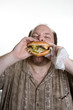 obese man eating fast food
