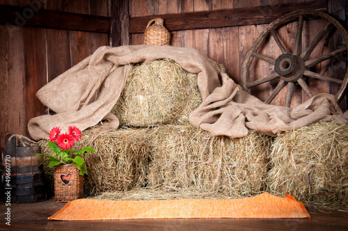 Photo: The interior of the building of the village. Wheel, hay, bucket, The interior of the building of the village. Wheel, hay, bucket,
