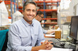 Businessman Working At Desk In Warehouse
