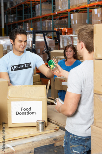 Photo: Volunteers Collecting Food Donations In Warehouse Volunteers Collecting Food Donations In Warehouse