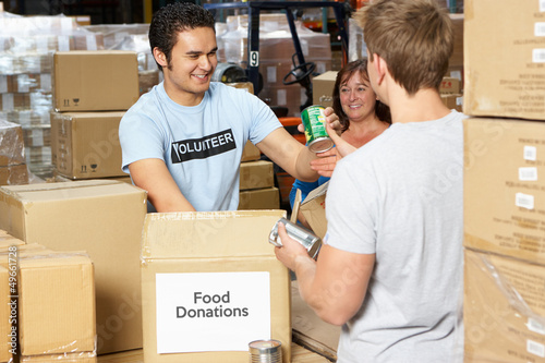 Photo: Volunteers Collecting Food Donations In Warehouse Volunteers Collecting Food Donations In Warehouse