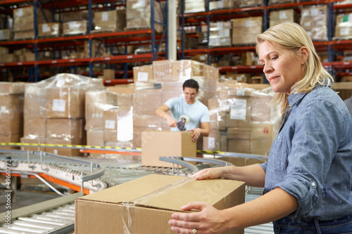 Photo: Workers In Distribution Warehouse Workers In Distribution Warehouse