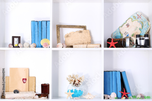 Photo: Beautiful white shelves with different travel related objects Beautiful white shelves with different travel related objects