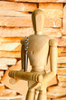 Mannequin with corkscrew, on brown wall background