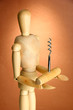 Mannequin with corkscrew, on brown background