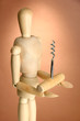 Mannequin with corkscrew, on brown background