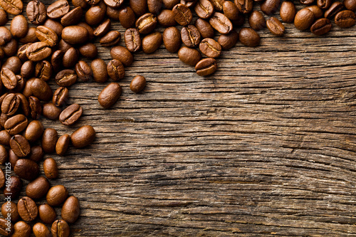 Photo: coffee beans on vintage wooden background coffee beans on vintage wooden background