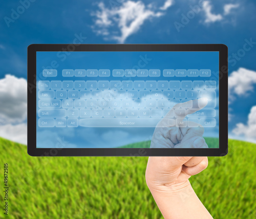 Photo: Hand pressing digital button on the black tablet. Hand pressing digital button on the black tablet.