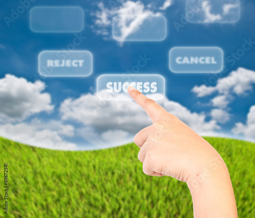 Photo: Hand pushing success word. Hand pushing success word.