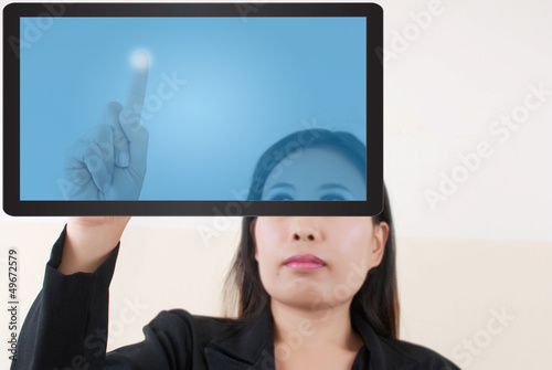 Photo: business lady pushing transparent keyboard on the whiteboard. business lady pushing transparent keyboard on the whiteboard.