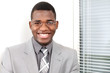 Business smile, young man by office window