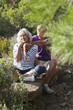 retired couple relaxing and hugging in the forest