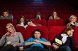 Group of boring people watching movie in cinema