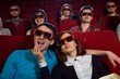 Group of people in 3D glasses watching movie in cinema