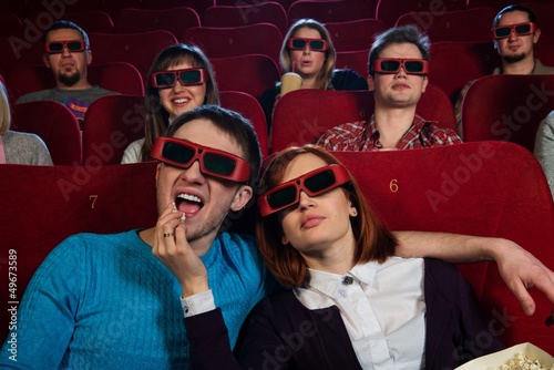 Photo: Group of people in 3D glasses watching movie in cinema Group of people in 3D glasses watching movie in cinema
