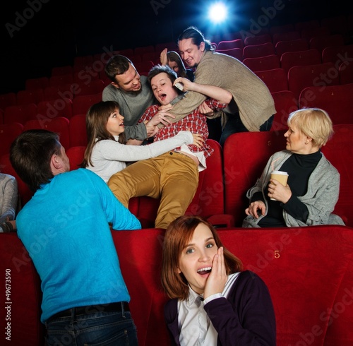 Photo: Fight between young men happening in cinema during film show Fight between young men happening in cinema during film show