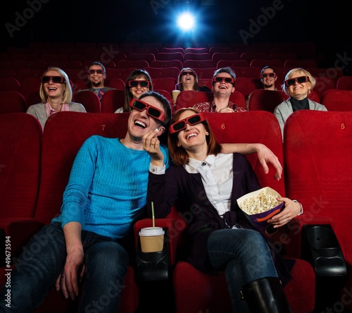 Photo: Group of people in 3D glasses watching movie in cinema Group of people in 3D glasses watching movie in cinema