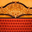 Back of expensive sofa with golden ornament
