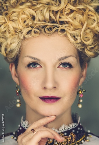 Photo: Portrait of beautiful haughty queen in royal dress Portrait of beautiful haughty queen in royal dress
